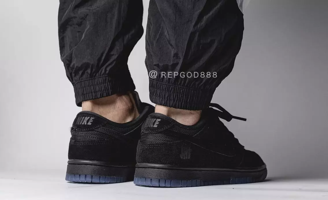 Võitmatu Nike Dunk madal must DO9329-001 väljalaskekuupäev jalgadel